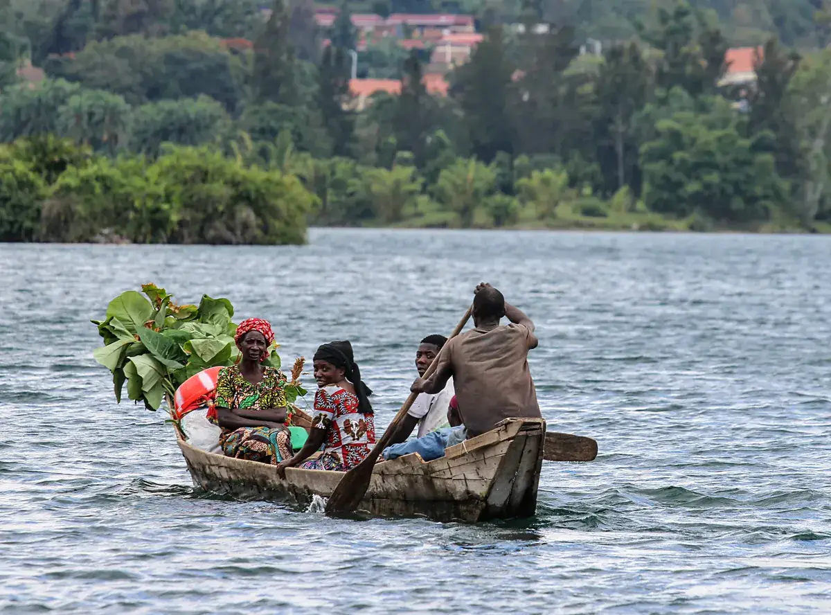 A farmer crossing Lake Kivu in a small wooden boat